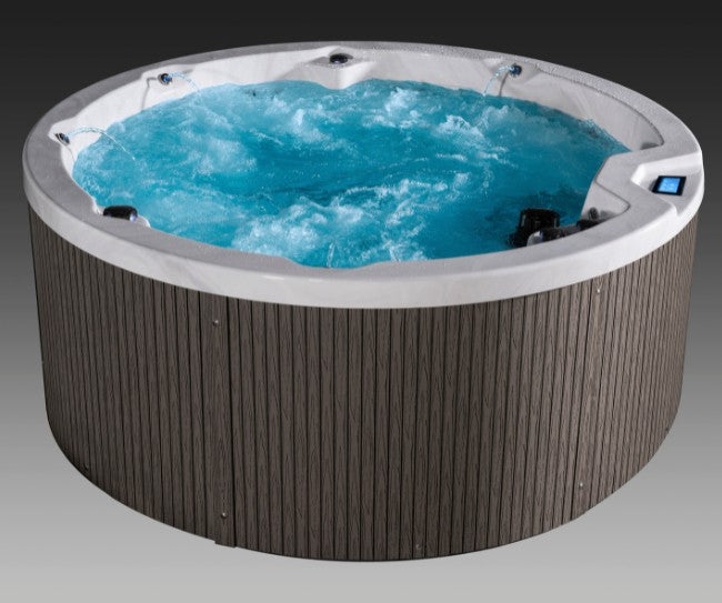Side-angle view of Icelandic Cyclone 3 spa with churning blue water and modern vertical paneling.