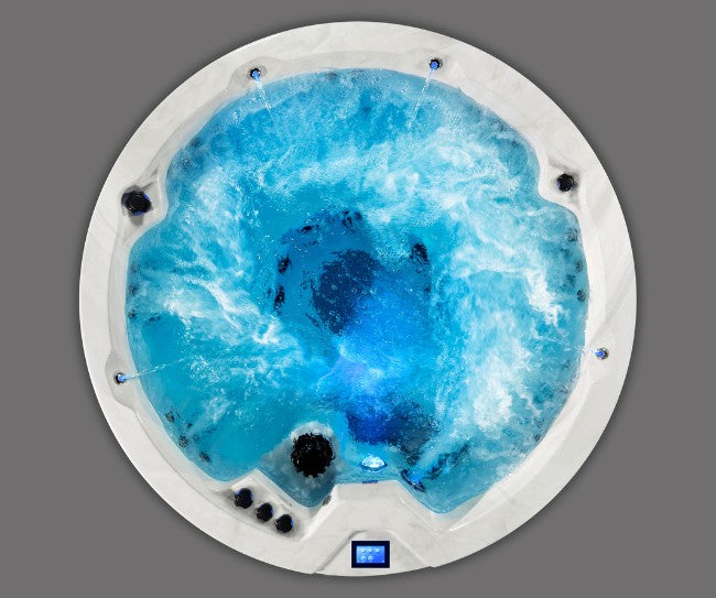 Top-down view of Icelandic Cyclone 3 spa with swirling blue water and multiple jets.