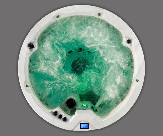 Top-down image of Icelandic Cyclone 3 spa featuring green LED lighting and swirling water.