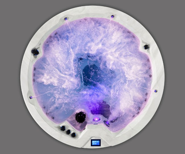 Top view of Icelandic Cyclone 3 spa illuminated with purple LED lighting and active jets.