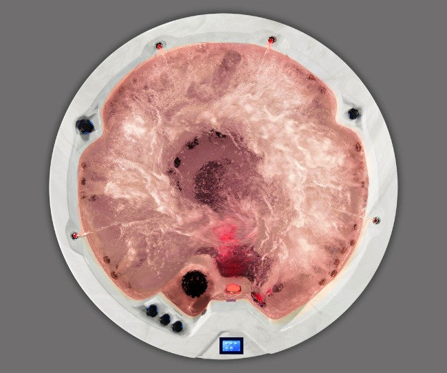 Overhead view of Icelandic Cyclone 3 hot tub glowing with red lighting during water circulation.