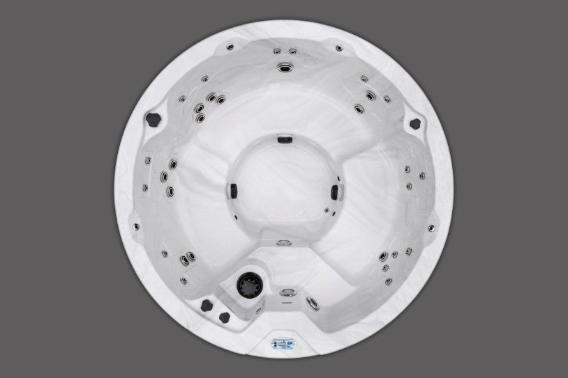 Overhead view of the Icelandic Wellness Cyclone 1 round hot tub showing full seating layout and jet configuration.