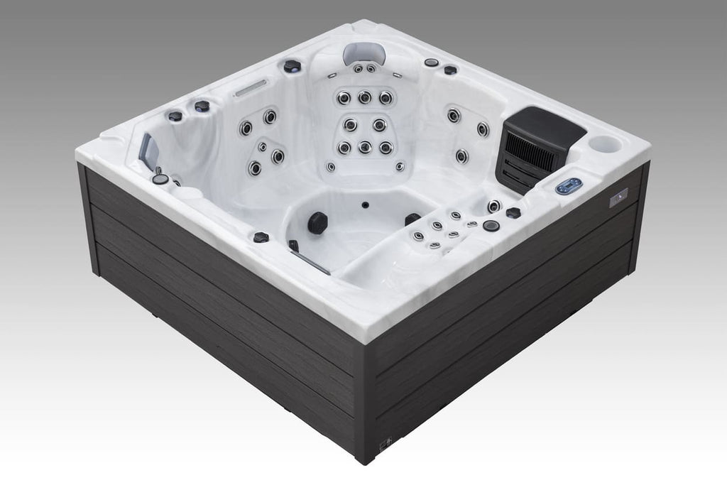 Angled view of the Icelandic Wellness Fjord hot tub with contoured white acrylic seating and jet system.