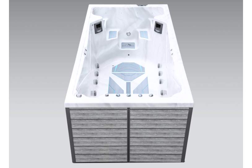 Front view of the Icelandic swim spa swim end featuring seating, jets, and control panel.