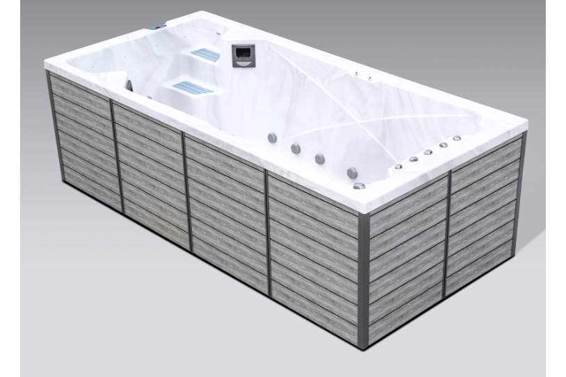 Side profile of the Icelandic swim spa with gray exterior panels and white acrylic interior.