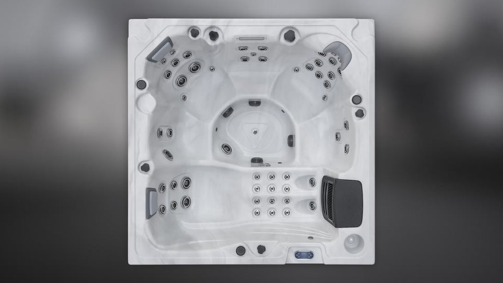 Top-down view of the Fjord luxury spa showing contoured seating, multiple hydrotherapy jets, center footwell, headrests, and control panel.