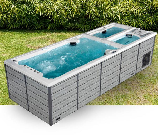 Triathlon 3-in-1 swim spa with swim zone, hot tub seats, and ice tub shown outdoors on a lawn.