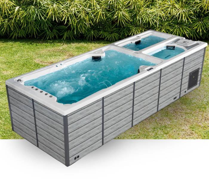 Triathlon 3-in-1 swim spa with swim zone, hot tub seats, and ice tub shown outdoors on a lawn.