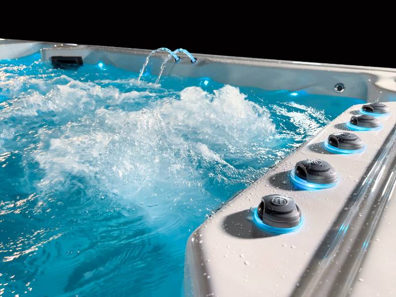 Close-up of the Triathlon 3-in-1 swim spa swim zone with jets and bubbling water.