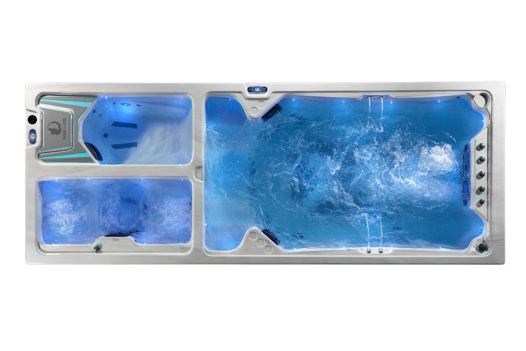 Top-down view of the Triathlon 3-in-1 swim spa with blue LED lighting across the swim, hot, and cold zones.