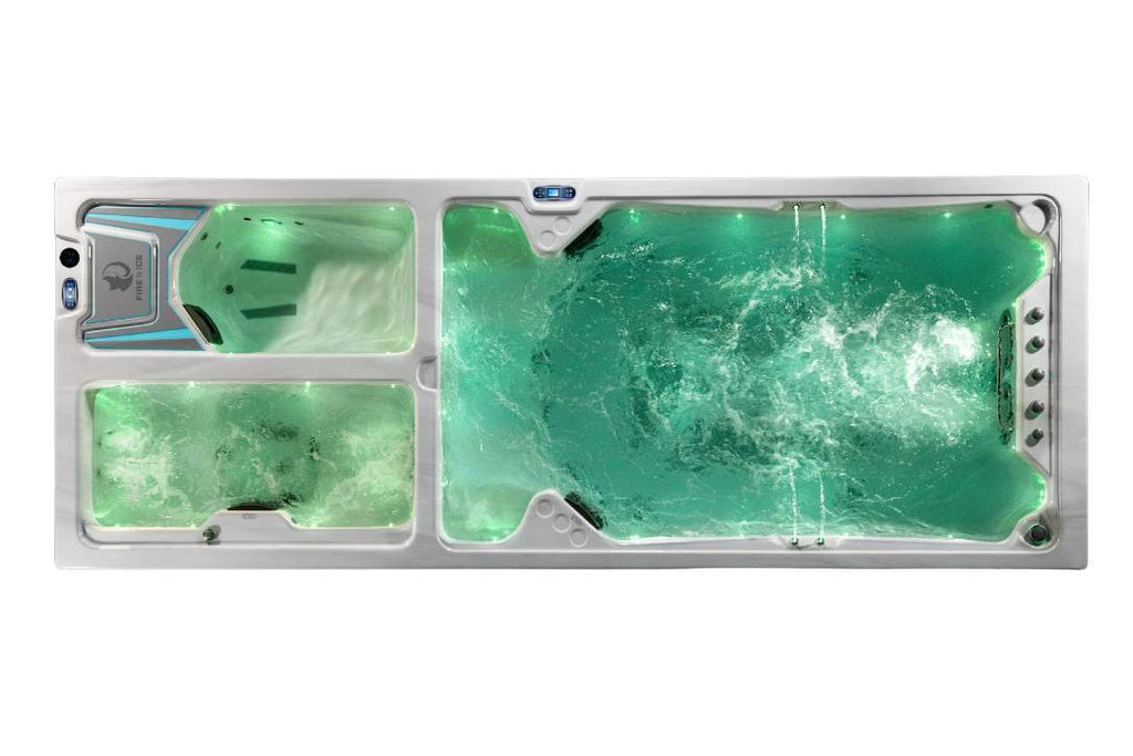 Top view of the Triathlon 3-in-1 swim spa illuminated with green LED lighting.