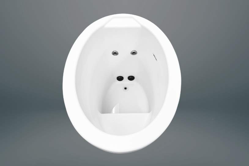 Angled top view of a white oval plunge tub showing jet placement and interior contouring.